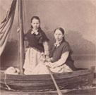 Two girls in a fake rowing boat